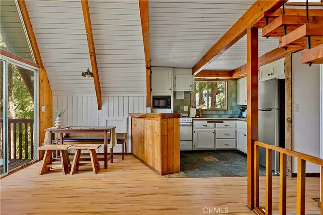 a dining room with furniture and wooden floor