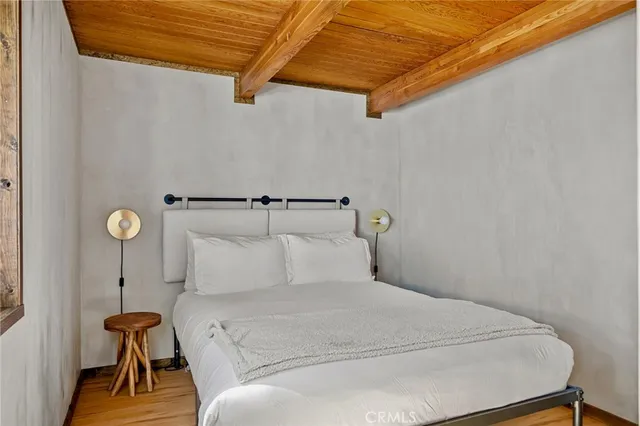 a bedroom with a bed and a table