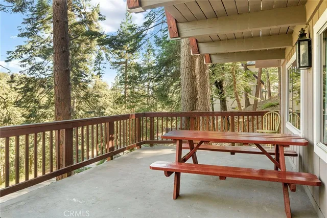 a view of balcony with wooden floor and seating space