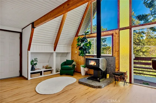 a living room with furniture and a floor to ceiling window