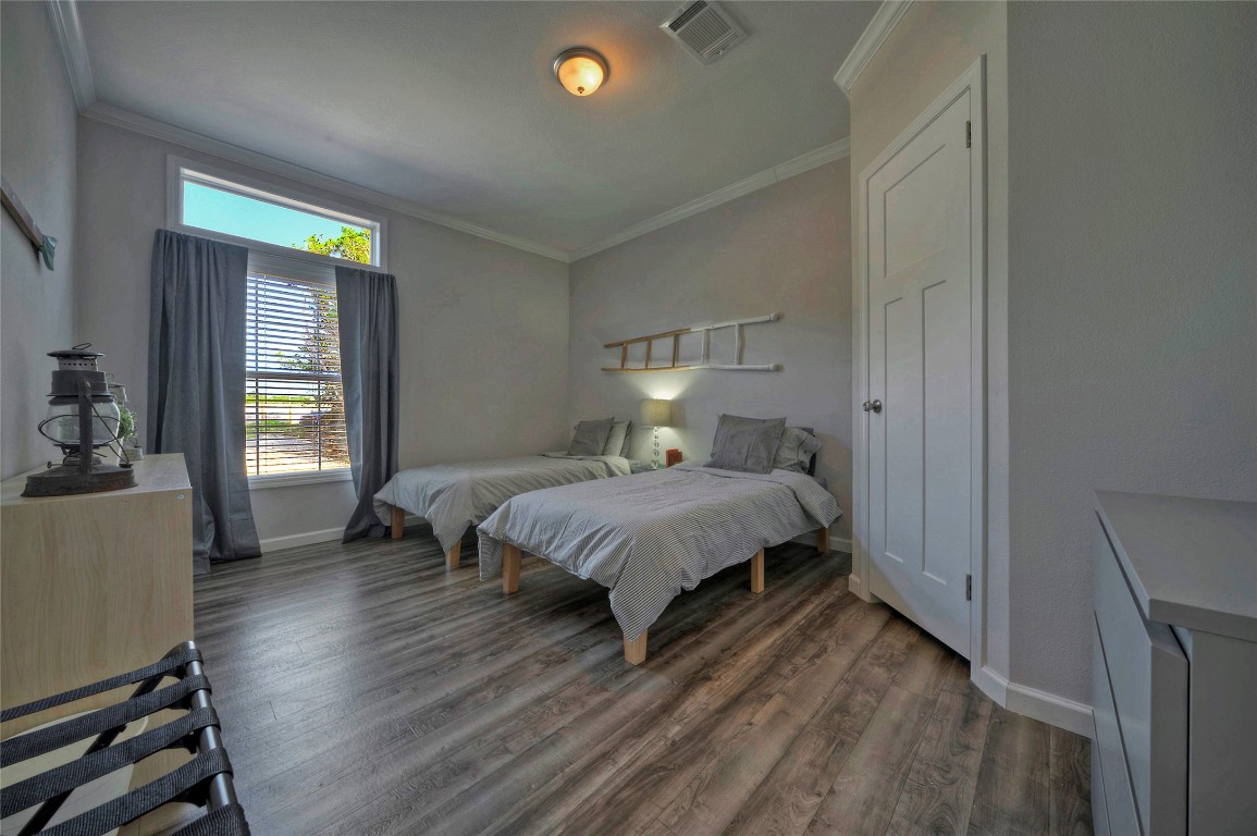 806 Bell Springs Road Dripping Springs, TX 78620 - Photo 14 of 34 a bed sitting in a bedroom next to a window