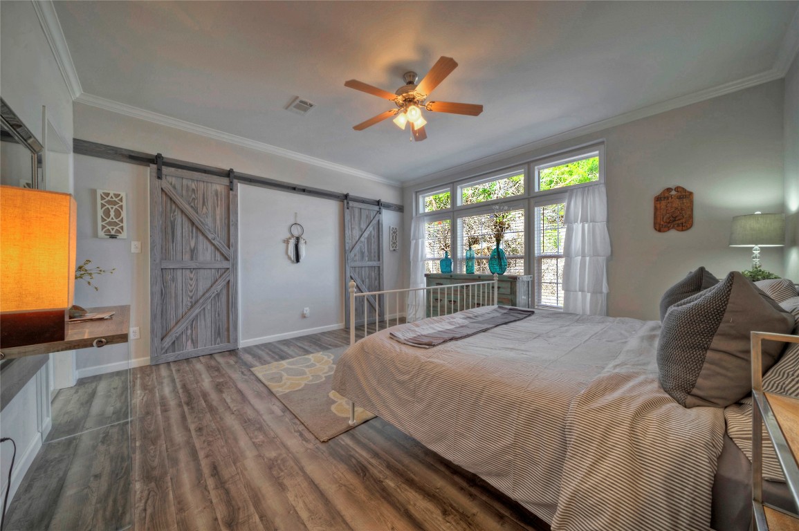 806 Bell Springs Road Dripping Springs, TX 78620 - Photo 15 of 34 a bedroom with a bed and glass walk in closet