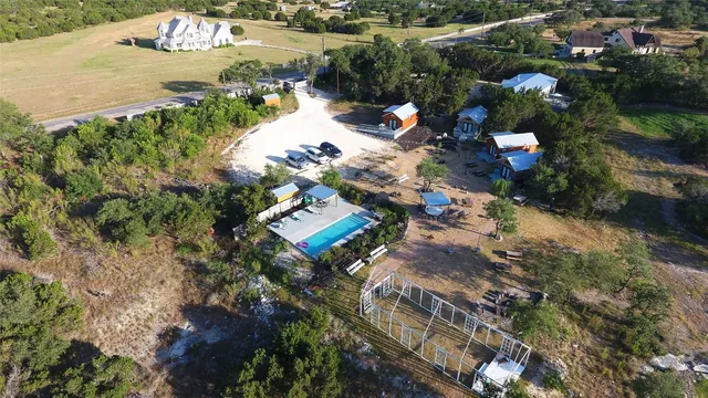 an aerial view of a house with a yard