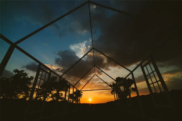 a backyard of a house with lots of green space and fountain