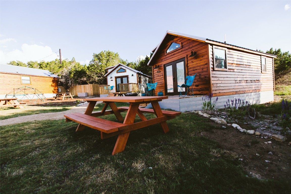 806 Bell Springs Road Dripping Springs, TX 78620 - Photo 25 of 34 a backyard of a house with table and chairs