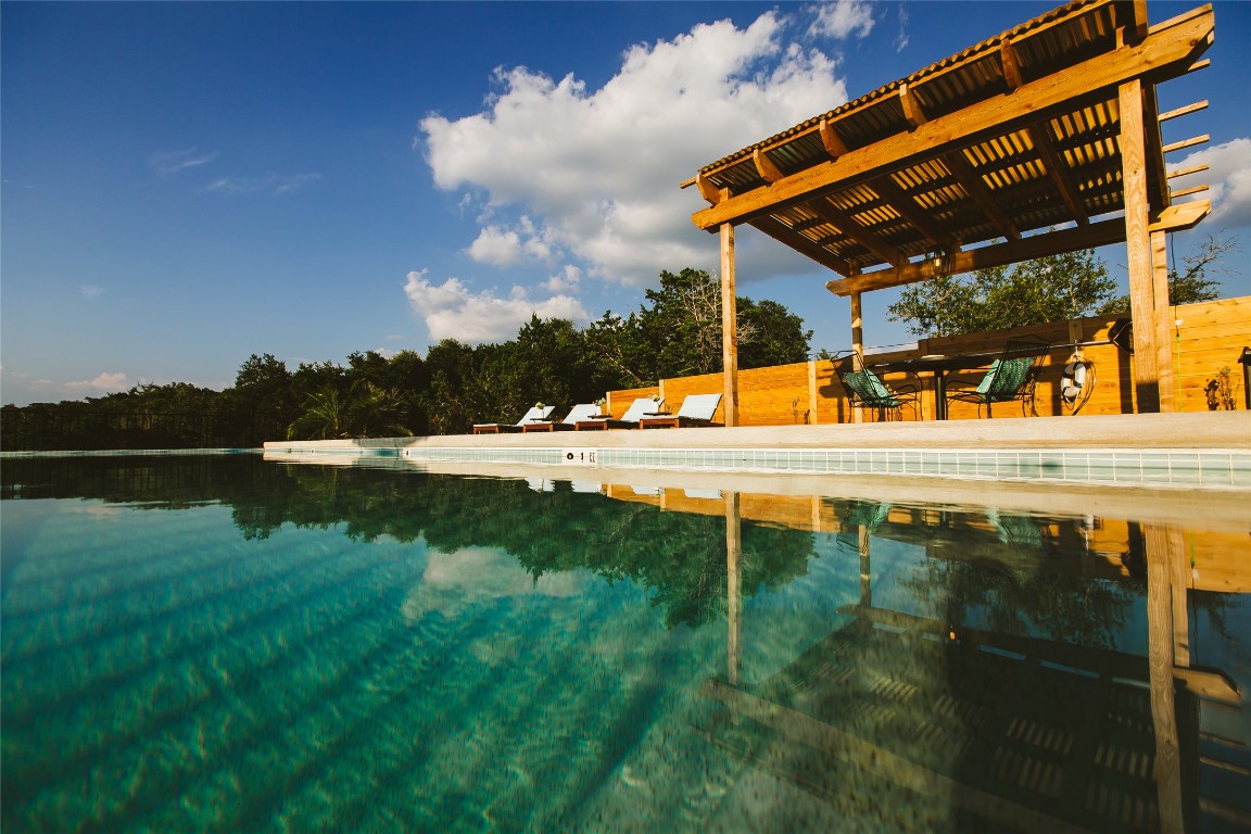 806 Bell Springs Road Dripping Springs, TX 78620 - Photo 26 of 34 a view of swimming pool with a yard and a fountain