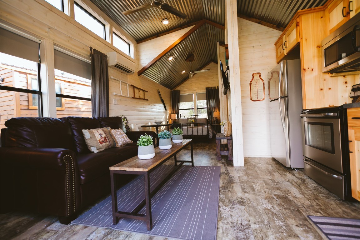 806 Bell Springs Road Dripping Springs, TX 78620 - Photo 5 of 34 a living room with furniture a fireplace and a flat screen tv