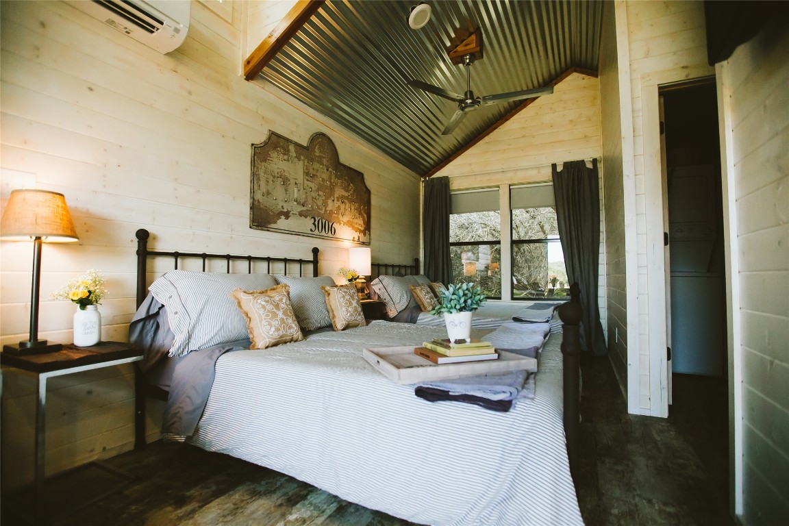 806 Bell Springs Road Dripping Springs, TX 78620 - Photo 7 of 34 a bedroom with a bed and wooden floor