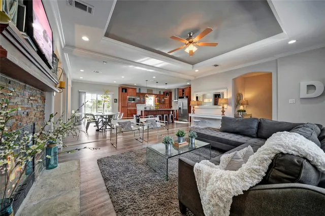 a living room with furniture and a chandelier