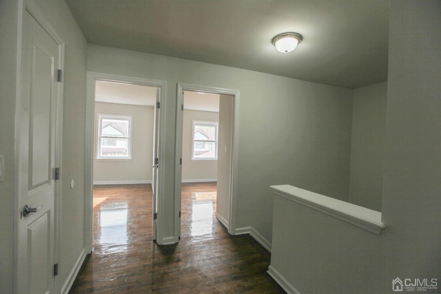 3704 Hana Road Edison, NJ 08817 - Photo 14 of 15 a view of an empty room with wooden floor and a window