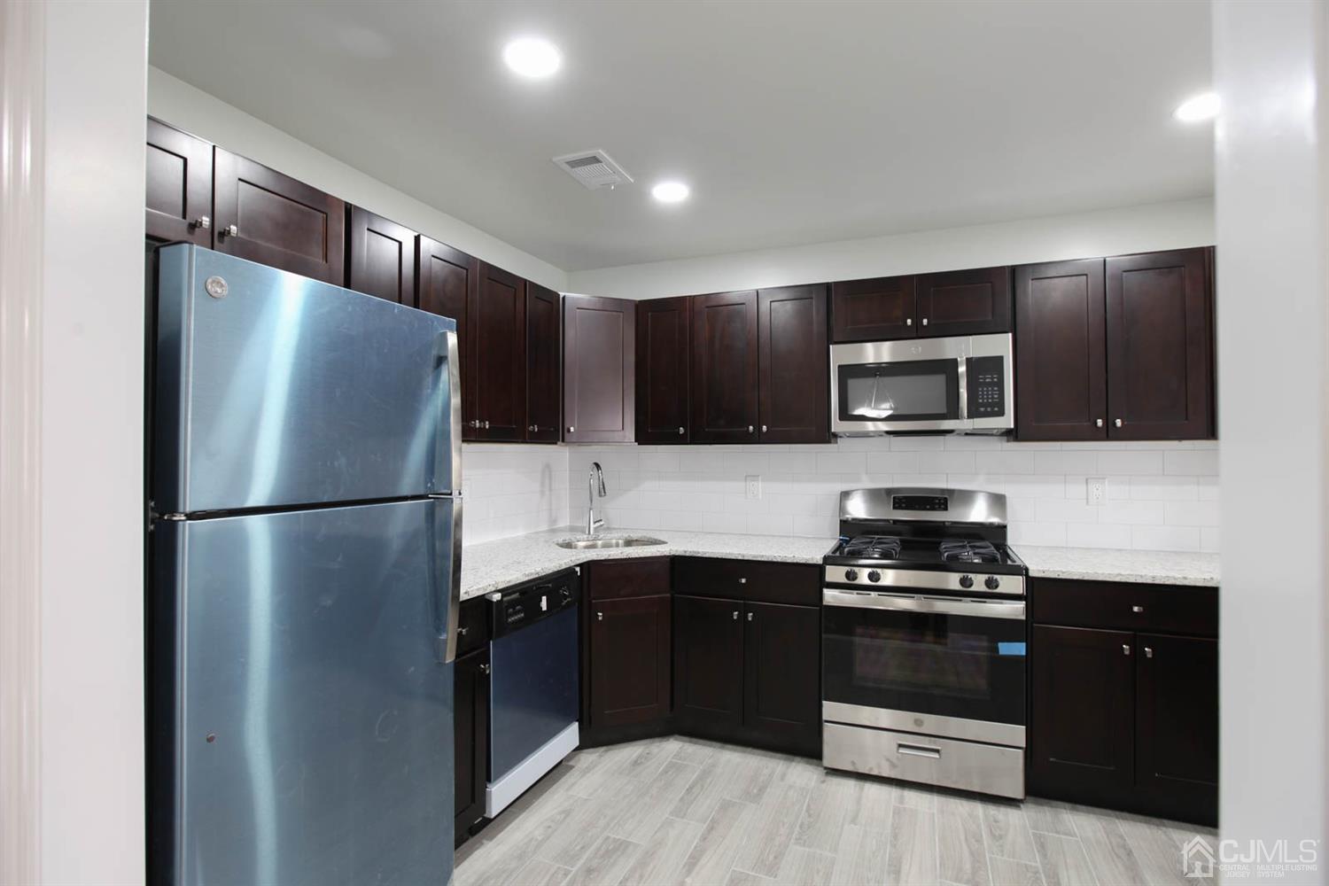 3704 Hana Road Edison, NJ 08817 - Photo 5 of 15 a kitchen with a refrigerator and a sink