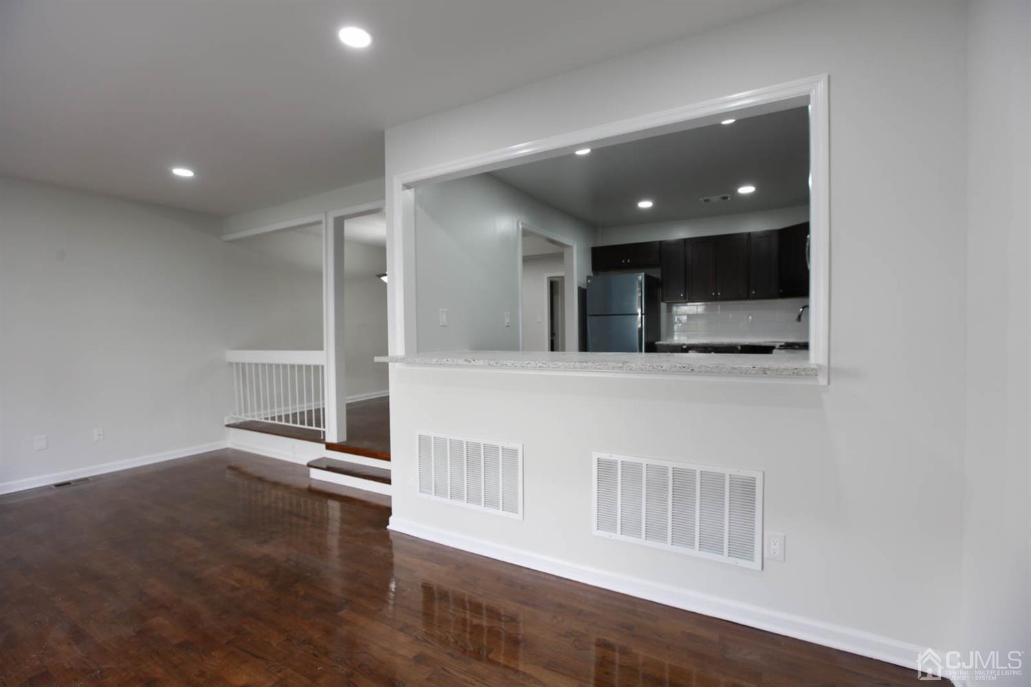 3704 Hana Road Edison, NJ 08817 - Photo 8 of 15 a view of a hallway with wooden floor and front door