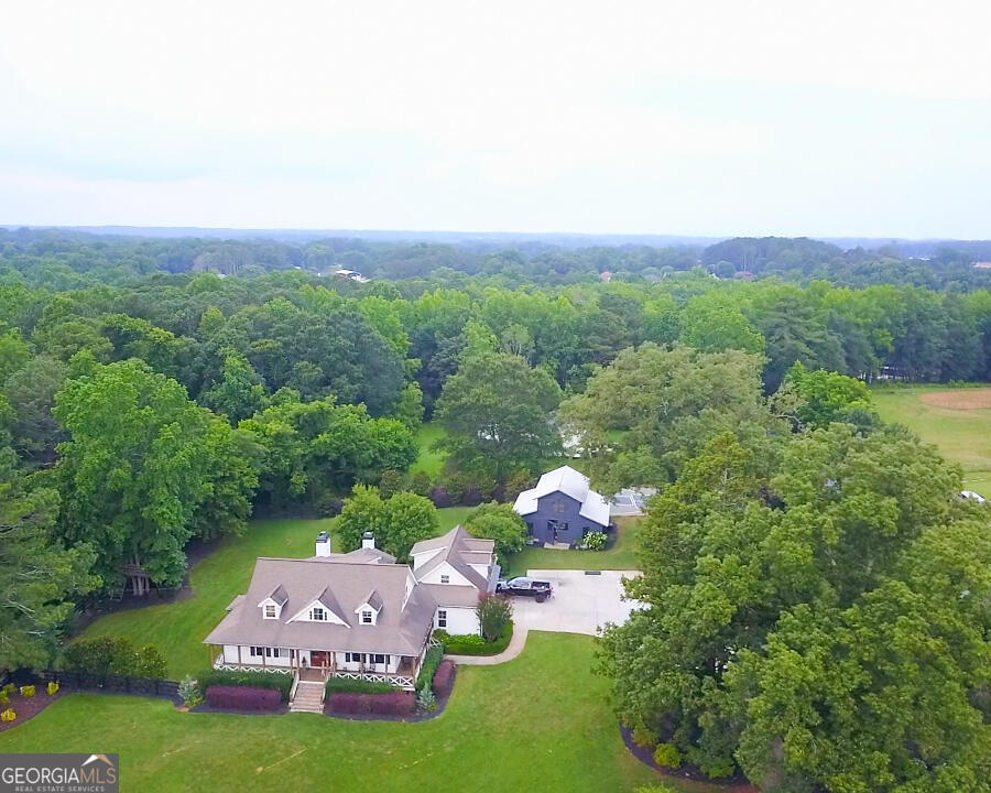 an aerial view of a house with garden space and street view