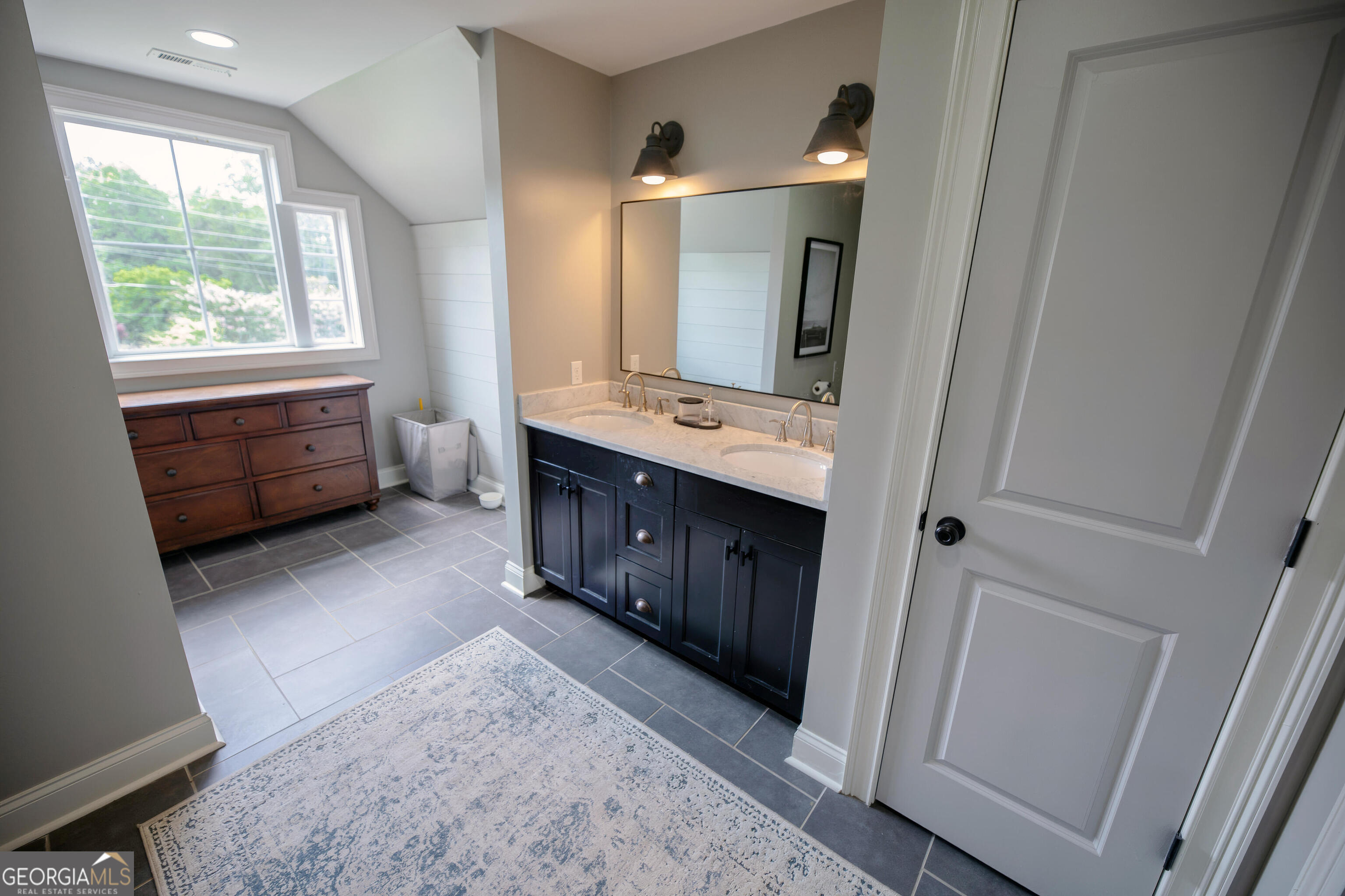 7093 Vaughn Road Woodstock, GA 30188 - Photo 24 of 41 a bathroom with a sink vanity granite tub and a mirror