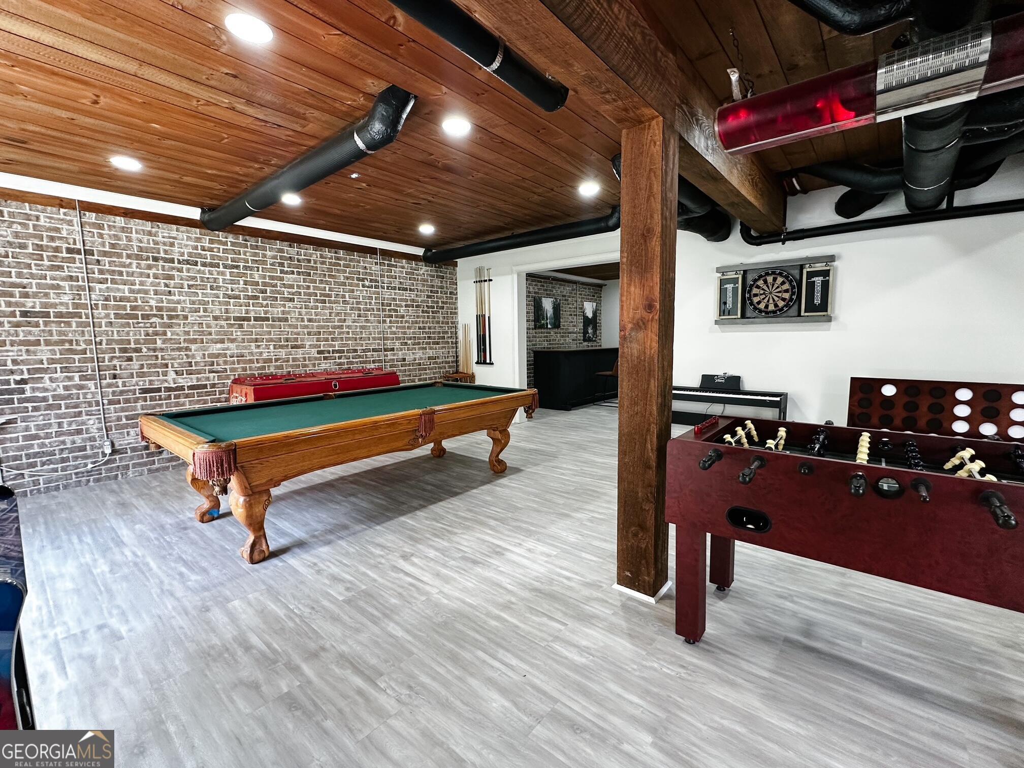 7093 Vaughn Road Woodstock, GA 30188 - Photo 36 of 41 a room with wooden furniture and gym equipment