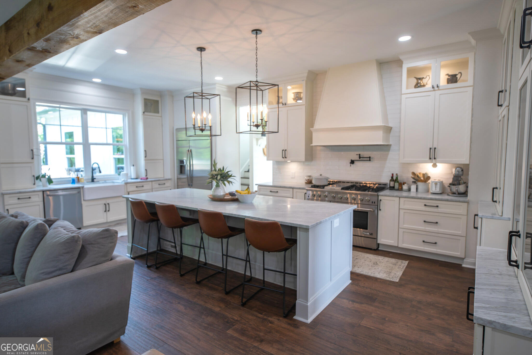 7093 Vaughn Road Woodstock, GA 30188 - Photo 6 of 41 a kitchen with granite countertop a sink cabinets and wooden floor