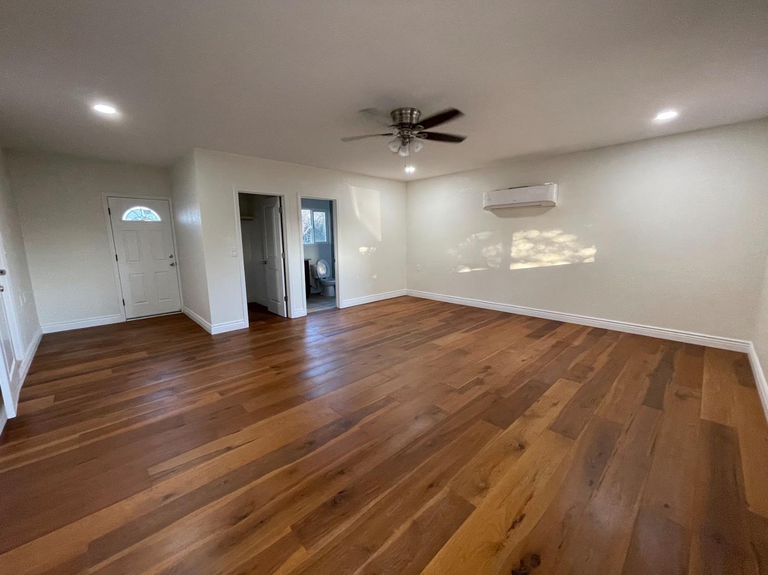 19342 East South Avenue Reedley, CA 93654 - Photo 11 of 29 a view of an empty room with wooden floor and a ceiling fan
