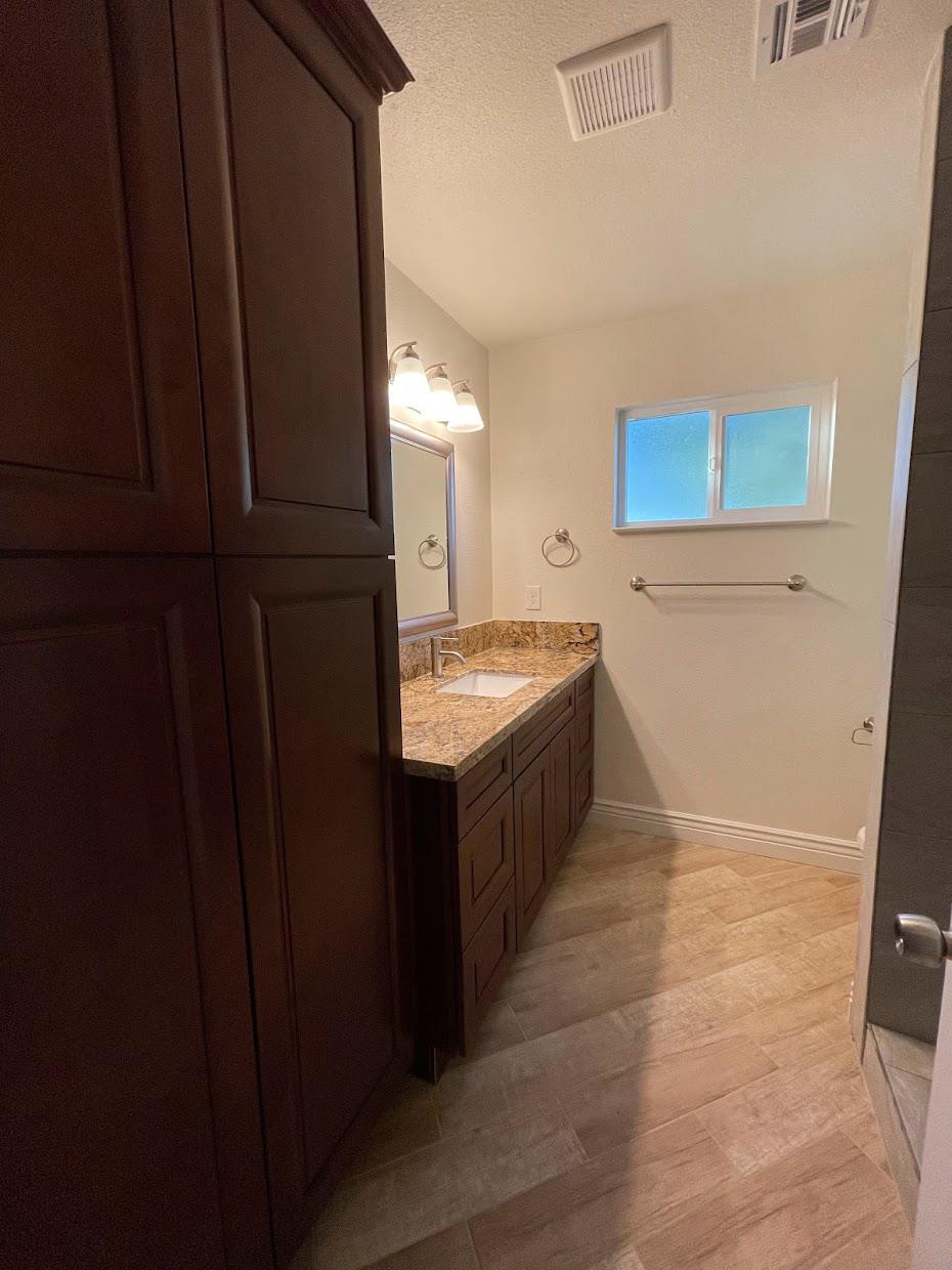 19342 East South Avenue Reedley, CA 93654 - Photo 15 of 29 a bathroom with a tub and a sink