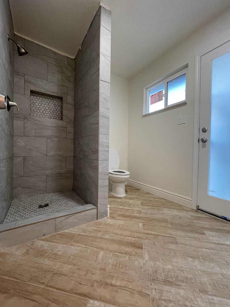 19342 East South Avenue Reedley, CA 93654 - Photo 22 of 29 a bathroom with a toilet and a shower