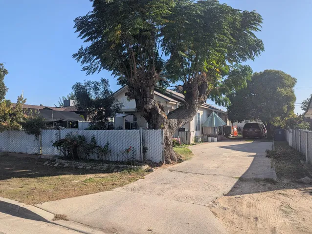 a view of a house with a yard covered with snow