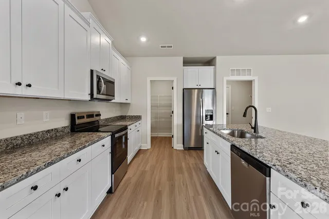 an empty room with a window and wooden floor