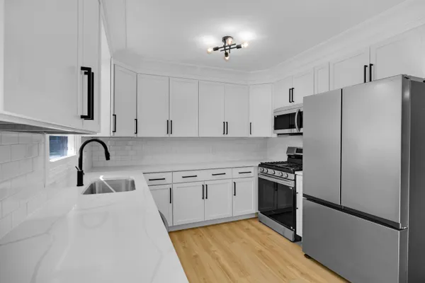 a view of a kitchen with a sink and a window