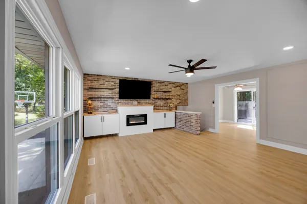 a view of a house with a big yard and large trees