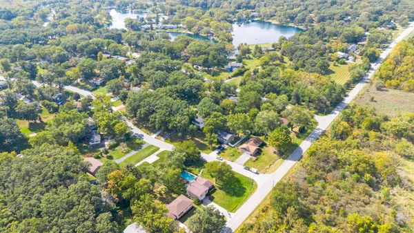 a view of a kitchen with a sink a fireplace wooden floor and window