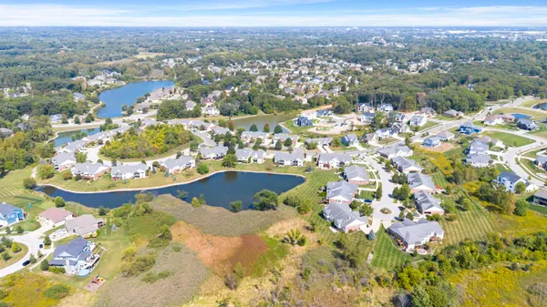 a view of a room with wooden floor and a ceiling fan