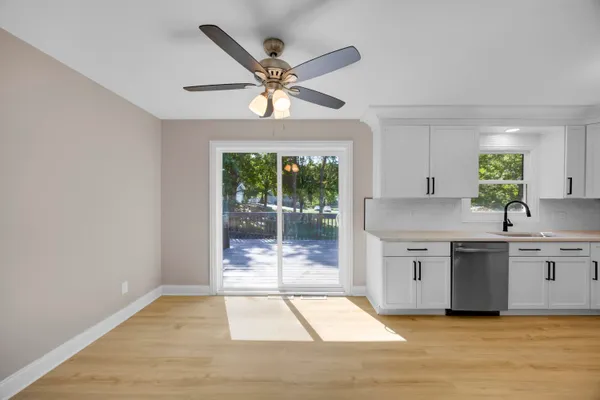 a bedroom with a bed and a potted plant on the dresser