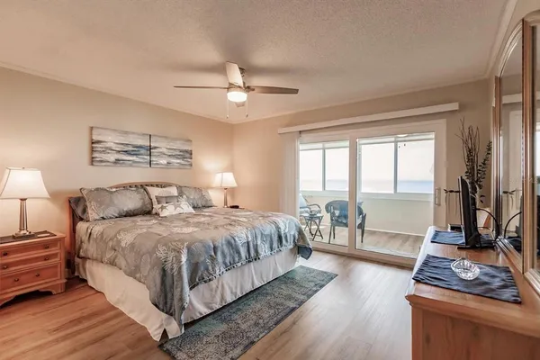 a bedroom with a large bed and a tv on dresser