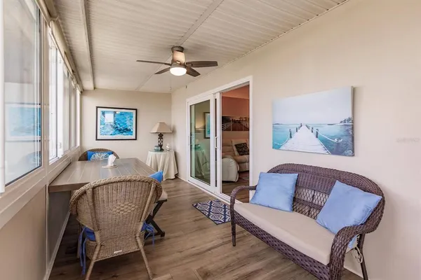 a dining room with furniture a chandelier and wooden floor