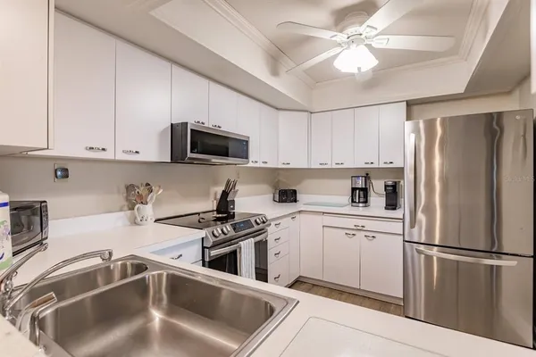a kitchen with a sink stove and cabinets