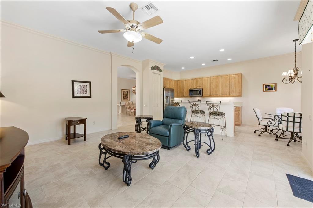 9097 Springview Loop Estero, FL 33928 - Photo 15 of 50 a living room with furniture and a chandelier