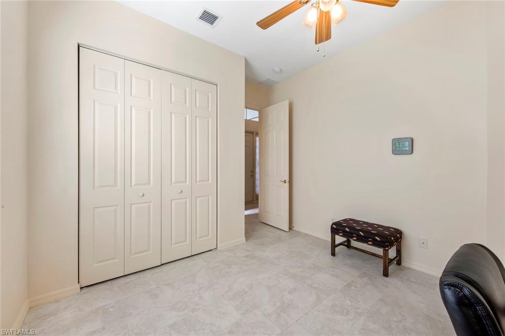 9097 Springview Loop Estero, FL 33928 - Photo 32 of 50 an empty room with a cabinet and chandelier