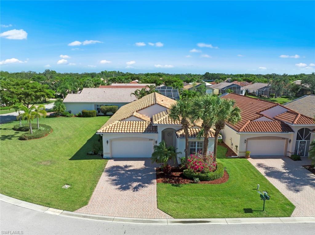 9097 Springview Loop Estero, FL 33928 - Photo 4 of 50 a front view of a house with a yard