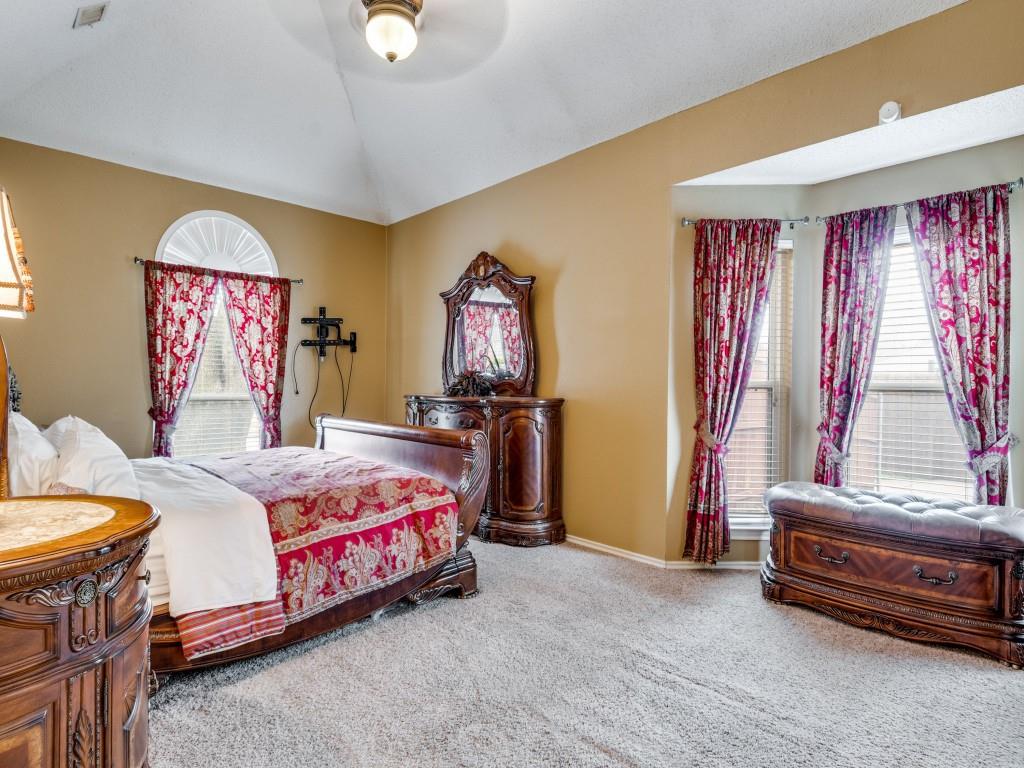 1317 Chestnut Drive Rowlett, TX 75089 - Photo 11 of 25 a bedroom with a bed and a chandelier