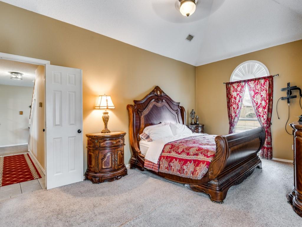 1317 Chestnut Drive Rowlett, TX 75089 - Photo 12 of 25 a bedroom with a bed and a lamp with wooden floor