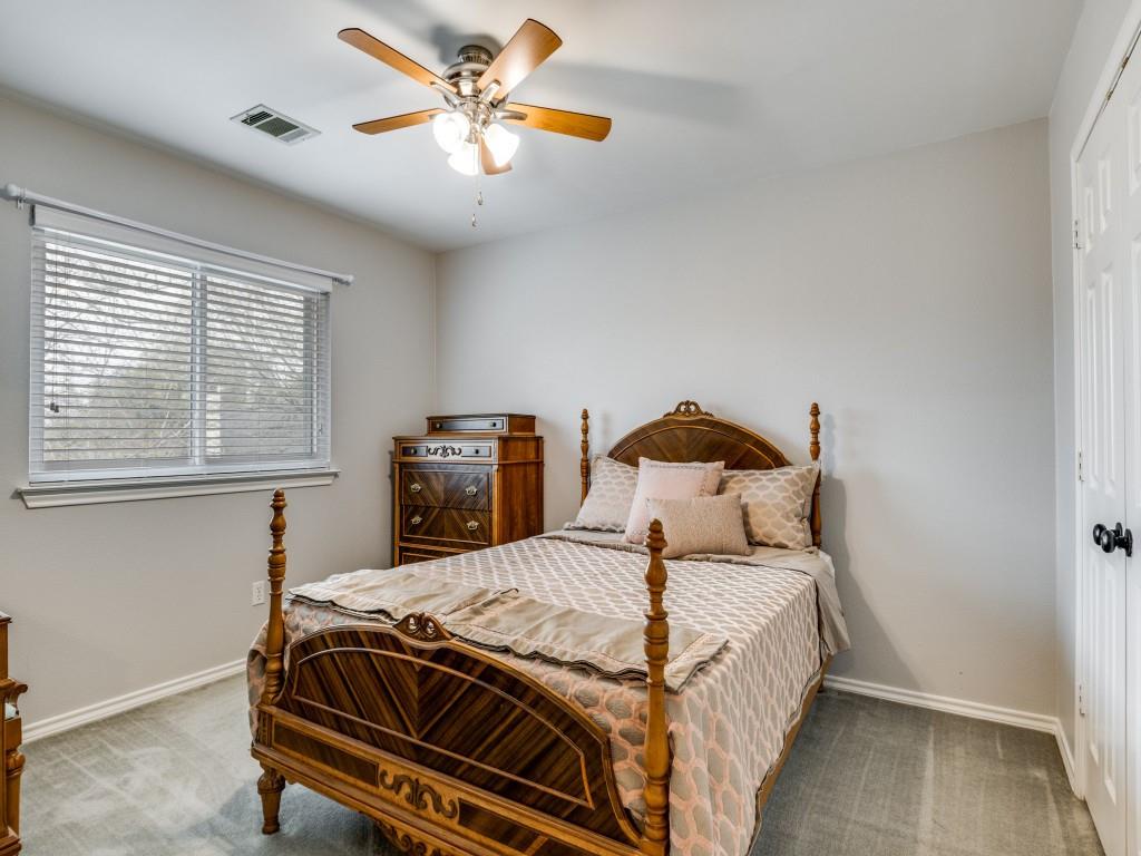 1317 Chestnut Drive Rowlett, TX 75089 - Photo 16 of 25 a bedroom with a bed and a chandelier
