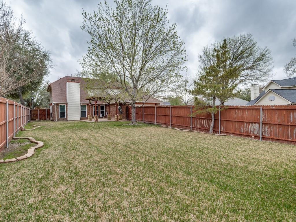 1317 Chestnut Drive Rowlett, TX 75089 - Photo 25 of 25 a view of a yard with large trees and wooden fence