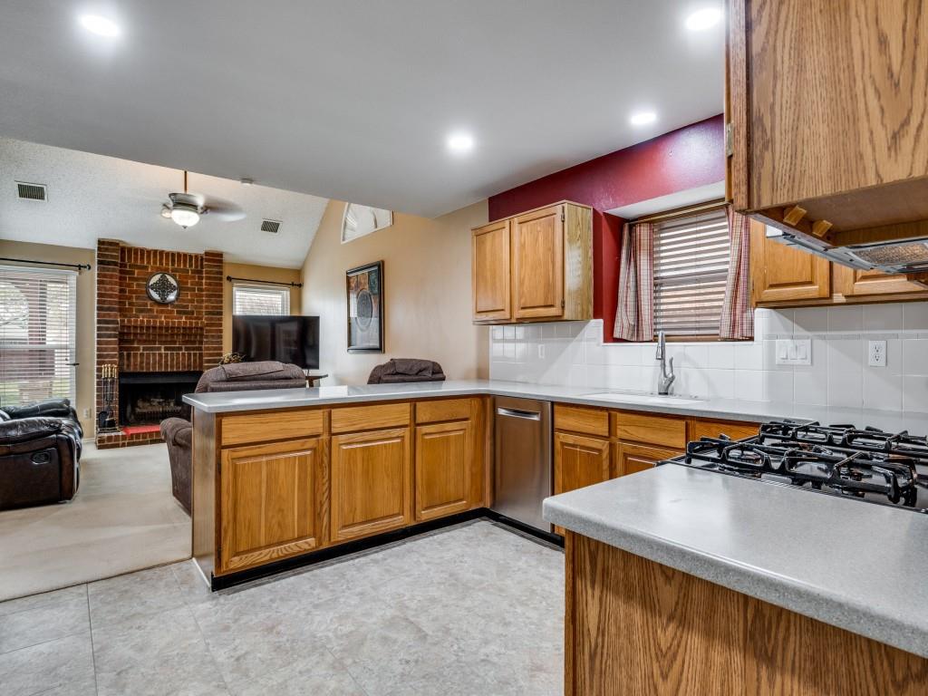 1317 Chestnut Drive Rowlett, TX 75089 - Photo 6 of 25 a kitchen with stainless steel appliances granite countertop a sink and cabinets