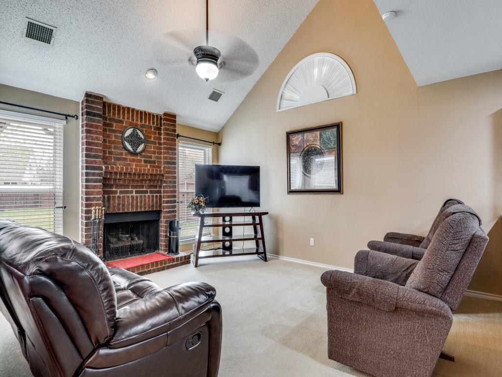 1317 Chestnut Drive Rowlett, TX 75089 - Photo 8 of 25 a living room with furniture a fireplace and a flat screen tv