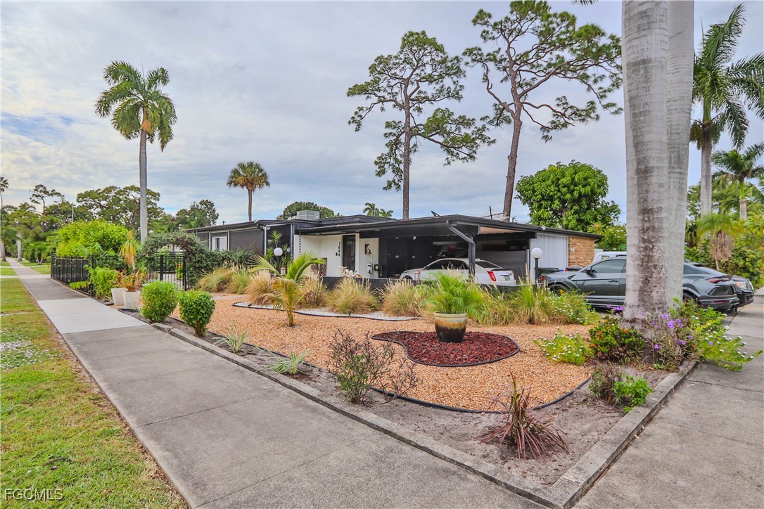 3666 Princeton Street Fort Myers, FL 33901 - Photo 1 of 38 a front view of a house with a garden and patio