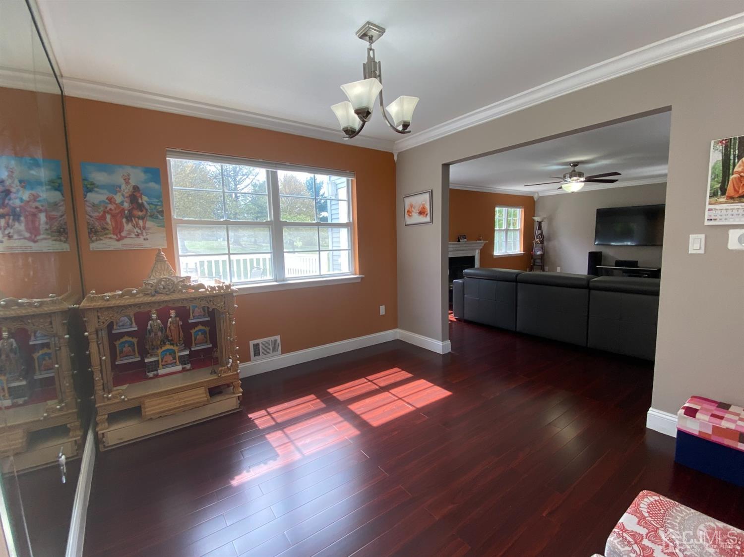 56 Whitehead Road Bridgewater, NJ 08807 - Photo 11 of 42 a living room with hard wood floors and a chandelier