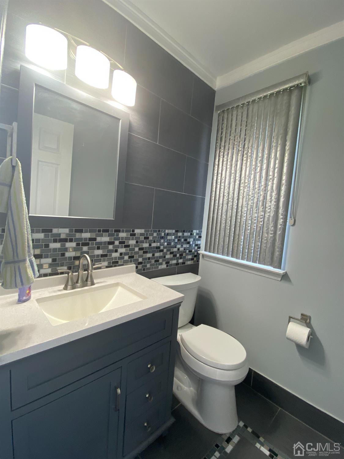 56 Whitehead Road Bridgewater, NJ 08807 - Photo 18 of 42 a bathroom with a toilet sink and mirror