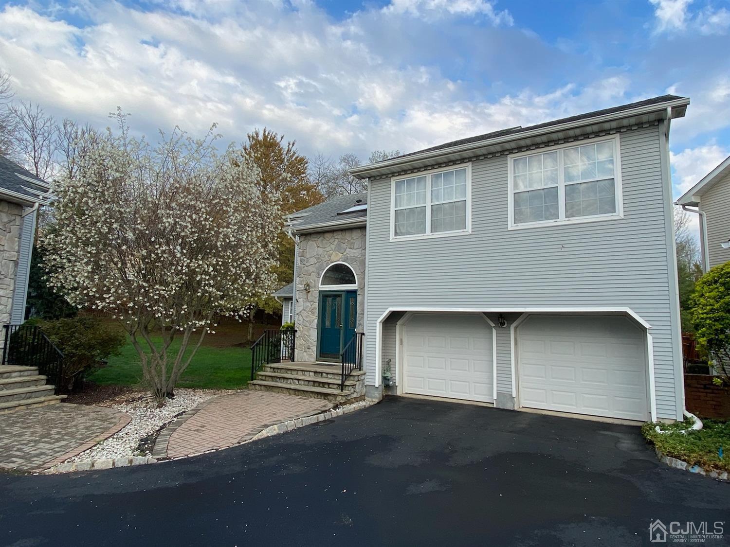 56 Whitehead Road Bridgewater, NJ 08807 - Photo 2 of 42 a front view of a house with a yard and garage