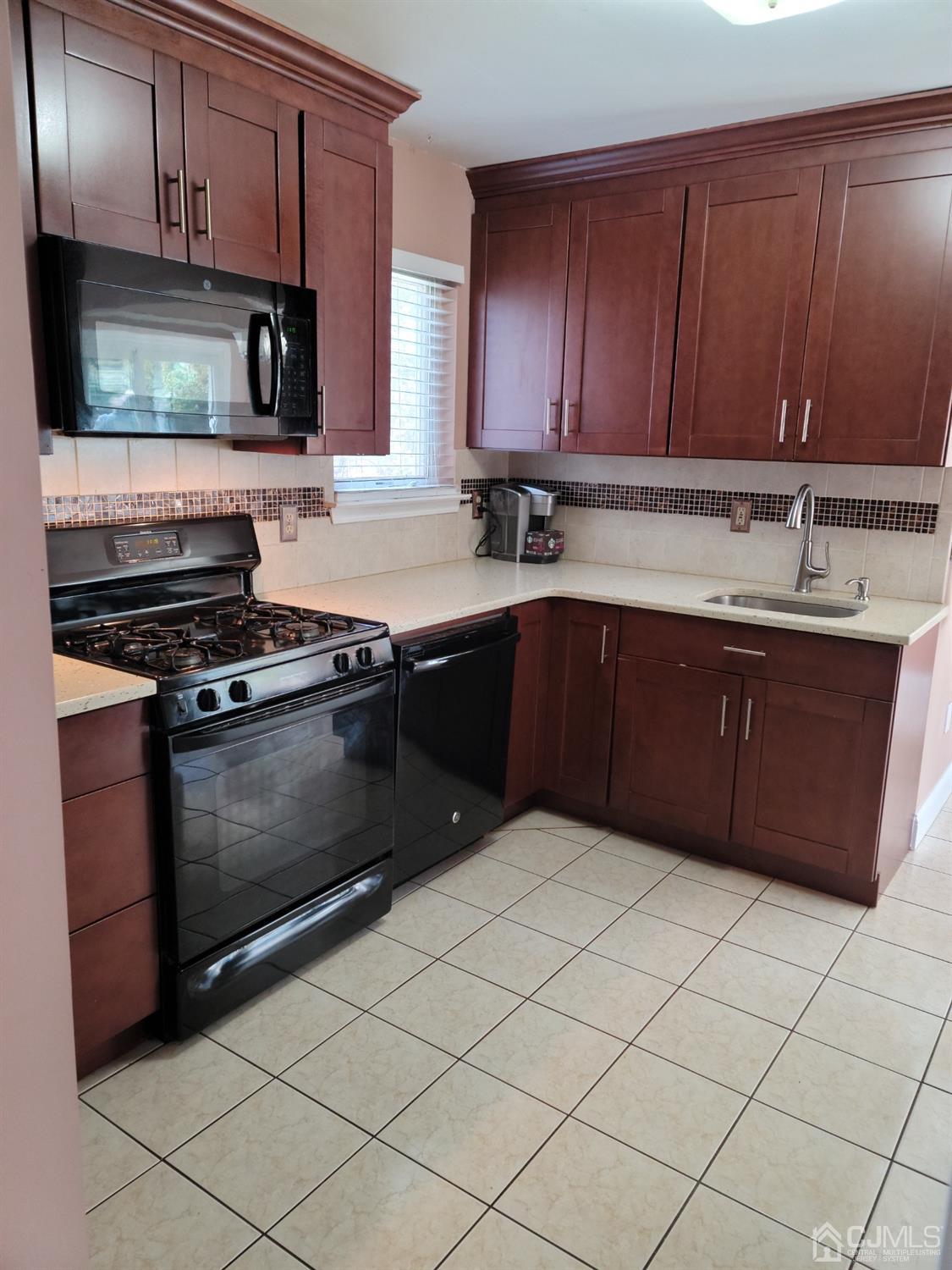 56 Whitehead Road Bridgewater, NJ 08807 - Photo 5 of 42 a kitchen with a sink and a stove