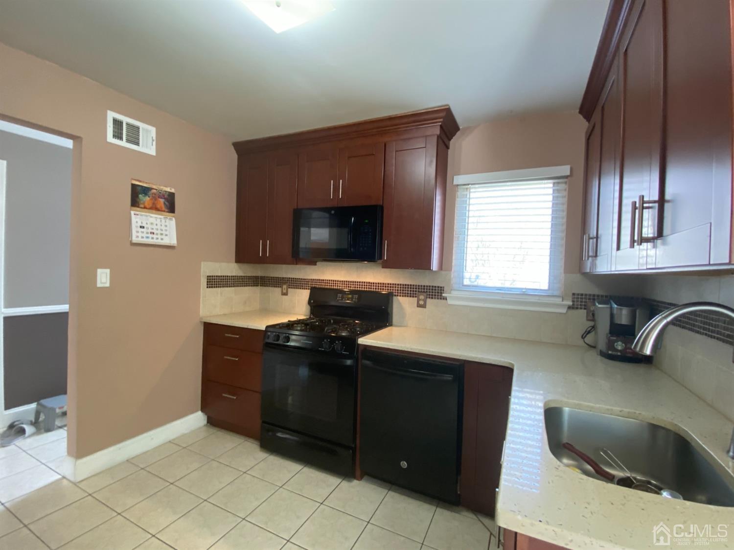 56 Whitehead Road Bridgewater, NJ 08807 - Photo 6 of 42 a kitchen with granite countertop a sink and a stove