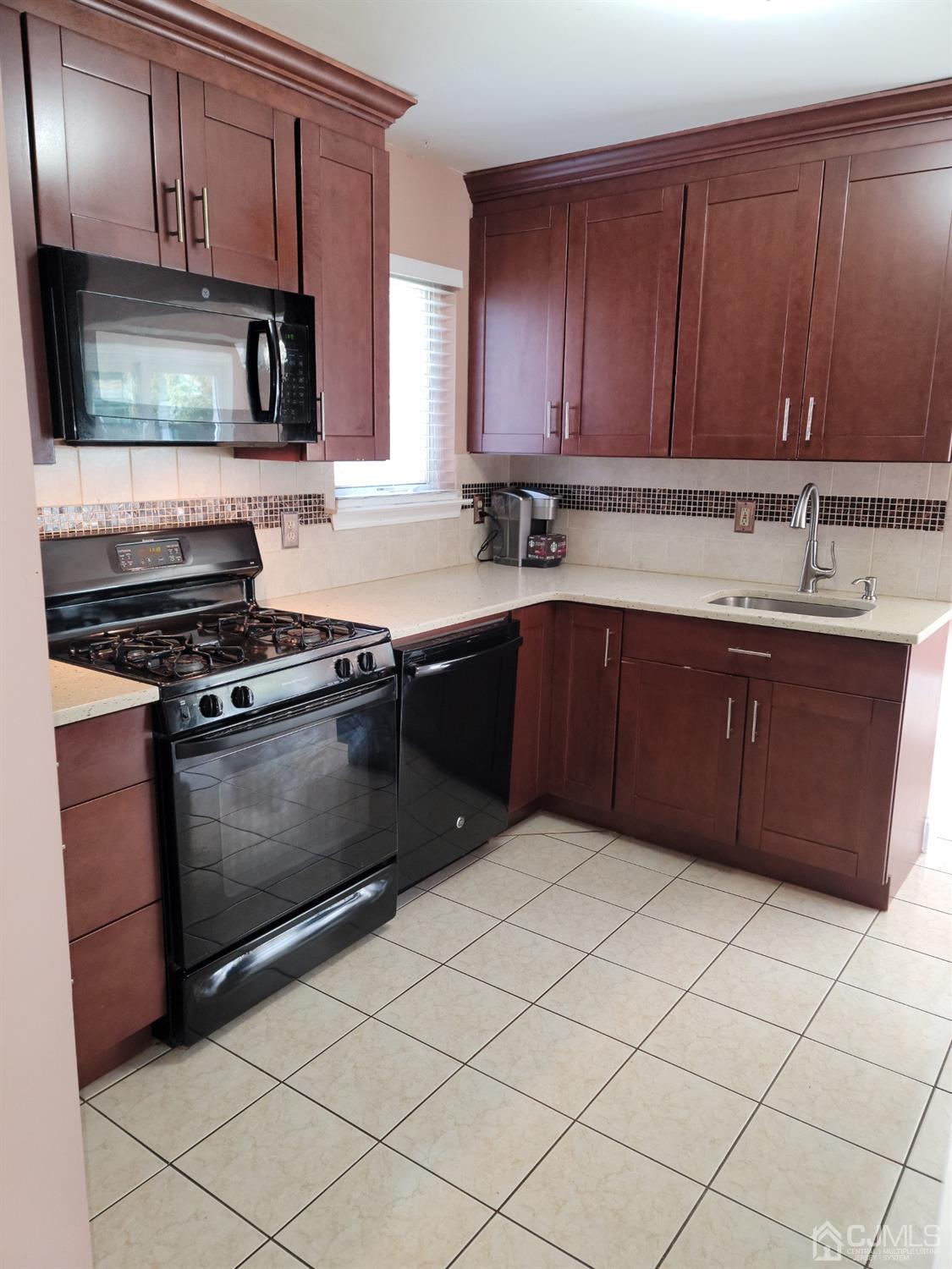 56 Whitehead Road Bridgewater, NJ 08807 - Photo 7 of 42 a kitchen with stainless steel appliances granite countertop a stove a sink and a microwave