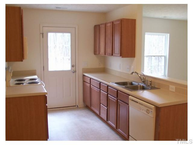 1928 Raj Drive Durham, NC 27703 - Photo 8 of 8 a kitchen with stainless steel appliances granite countertop a sink stove and refrigerator